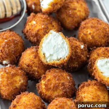 Crispy Fried Goat Cheese Balls with Honey Dip 15 Metal pan with fried goat cheese balls.