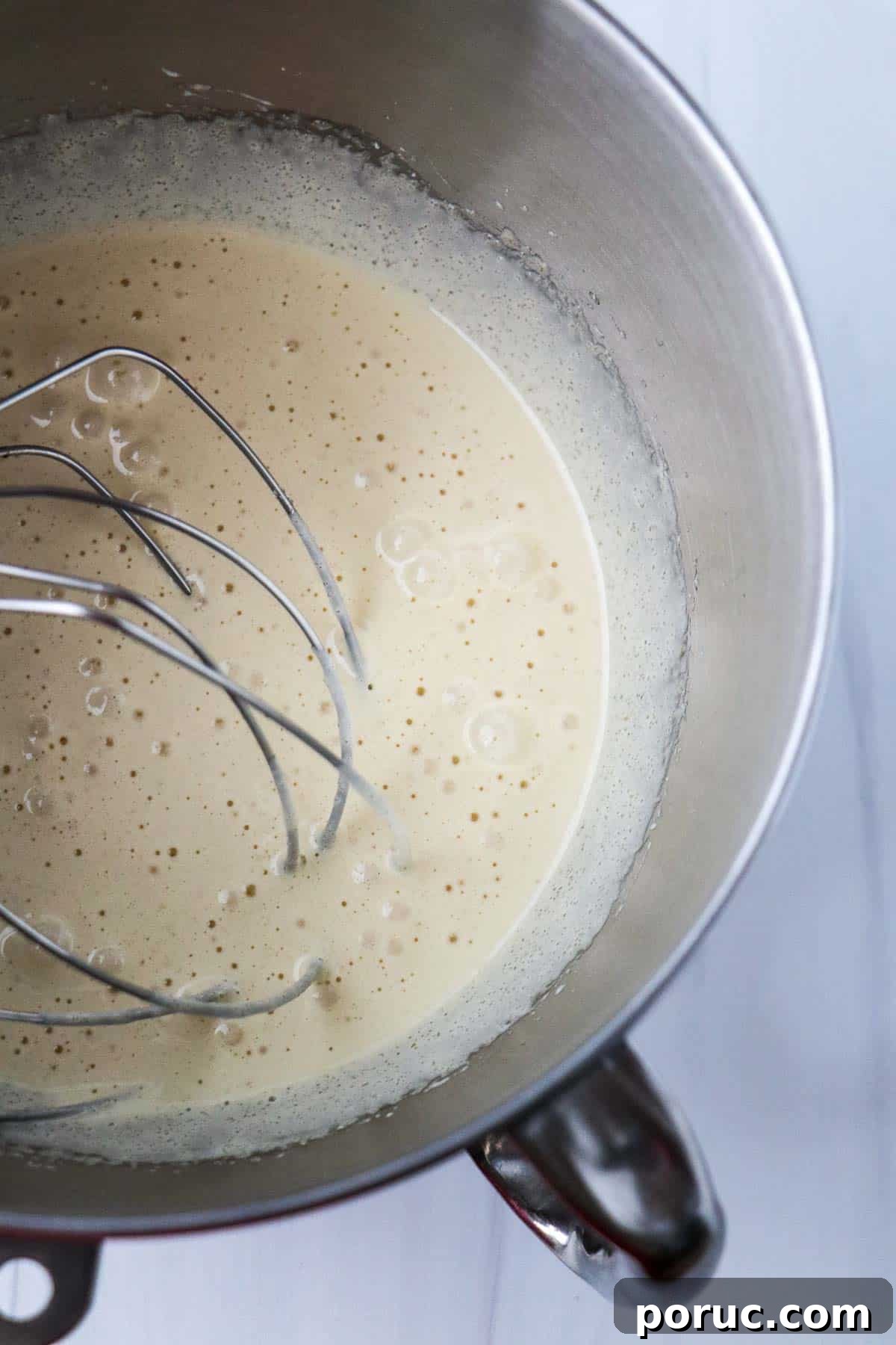 Vanilla Layer Cake with Strawberry Filling — Swedish Midsummer Cake 11 Whipped sugar and eggs in a metal bowl with a whisk attachment.