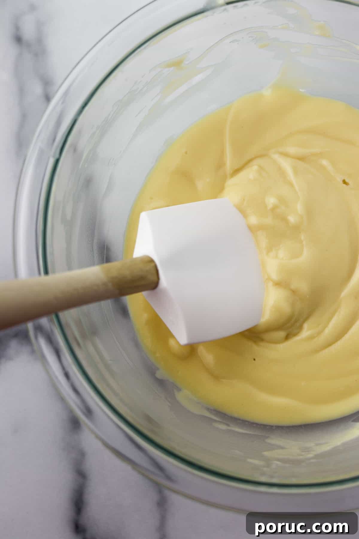 Vanilla Layer Cake with Strawberry Filling — Swedish Midsummer Cake 13 Pastry cream in a glass bowl with a rubber spatula.