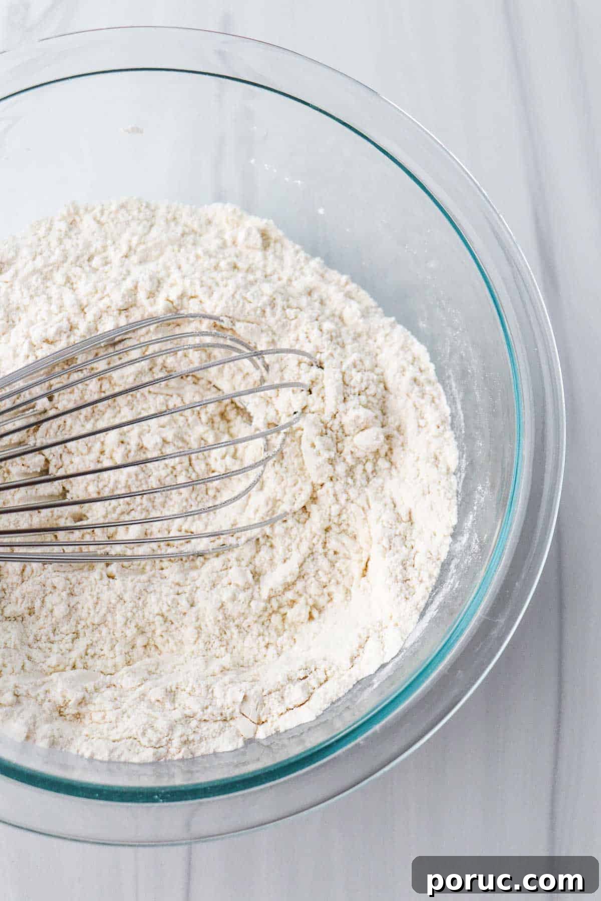 Vanilla Layer Cake with Strawberry Filling — Swedish Midsummer Cake 10 Flour in a glass bowl with a whisk.