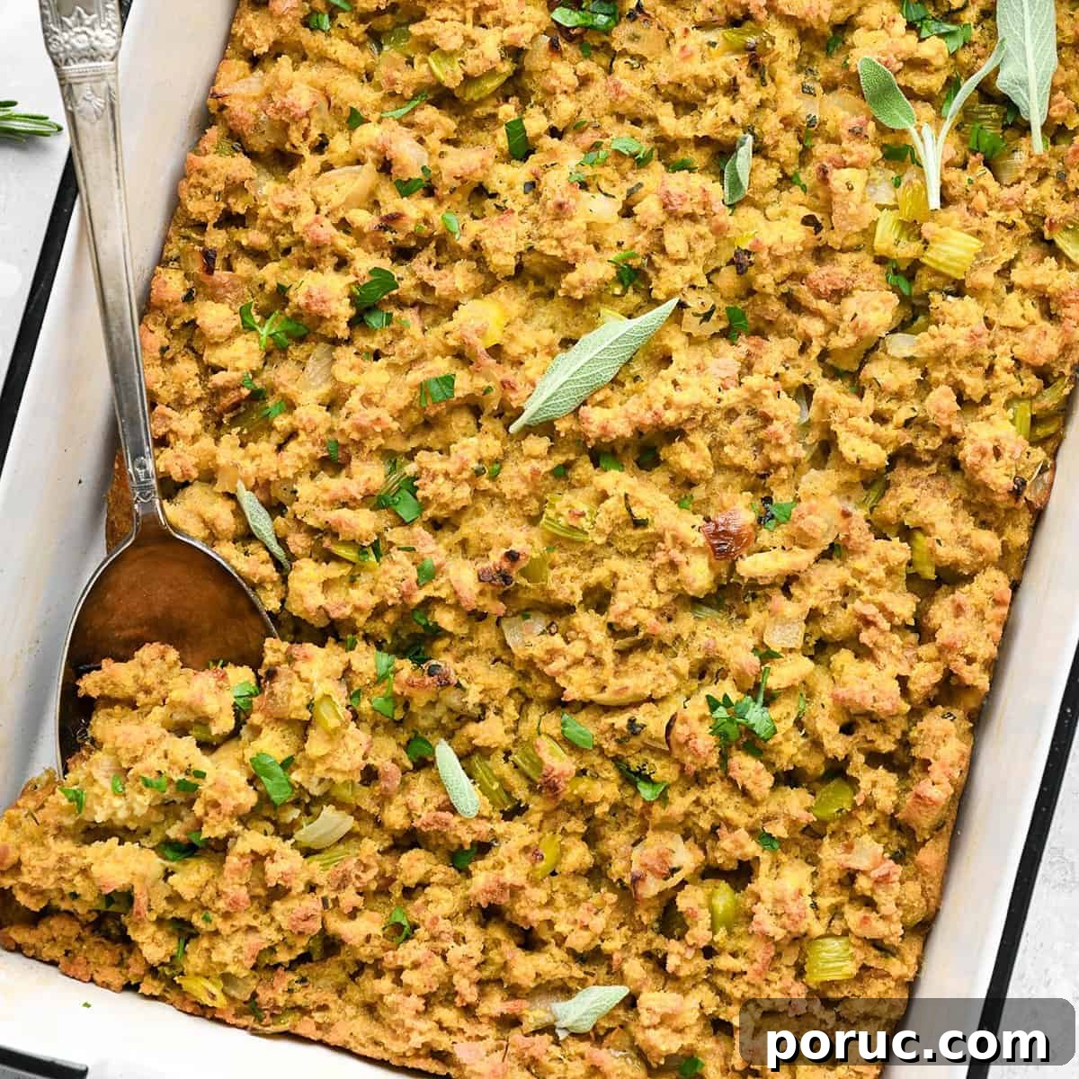 Southern Cornbread Dressing Recipe — Classic Holiday Side Dish 10 cornbread stuffing in a baking dish with a spoon