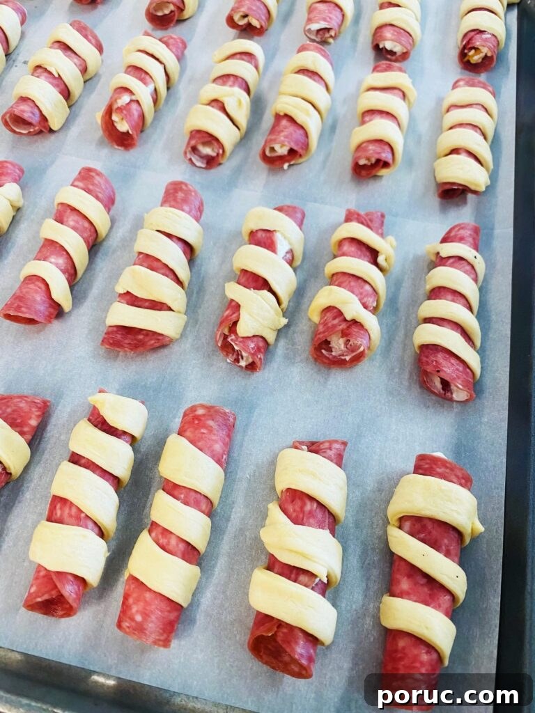 Savory Crescent Salami Roll-Ups for Appetizers and Parties 6 tray of uncooked salami rolls