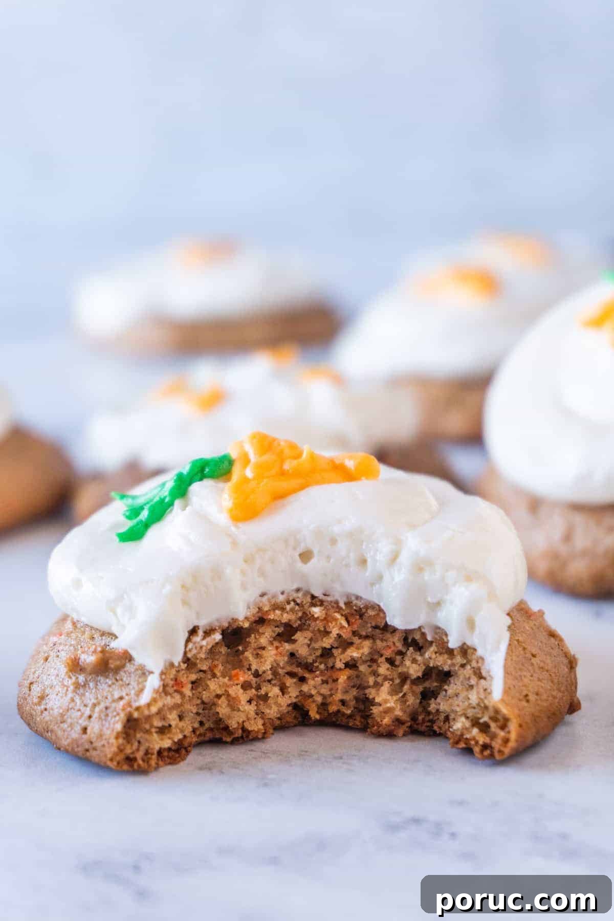 Frosted Carrot Cake Cookie with a bite taken out of it.