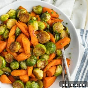 Spicy Honey-Roasted Brussels Sprouts and Carrots 11 This is a square picture of a plate filled with roasted Brussels sprouts and carrots with hot honey.
