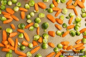 Spicy Honey-Roasted Brussels Sprouts and Carrots 15 This is a picture of the veggies on a baking tray placed on a single layer.