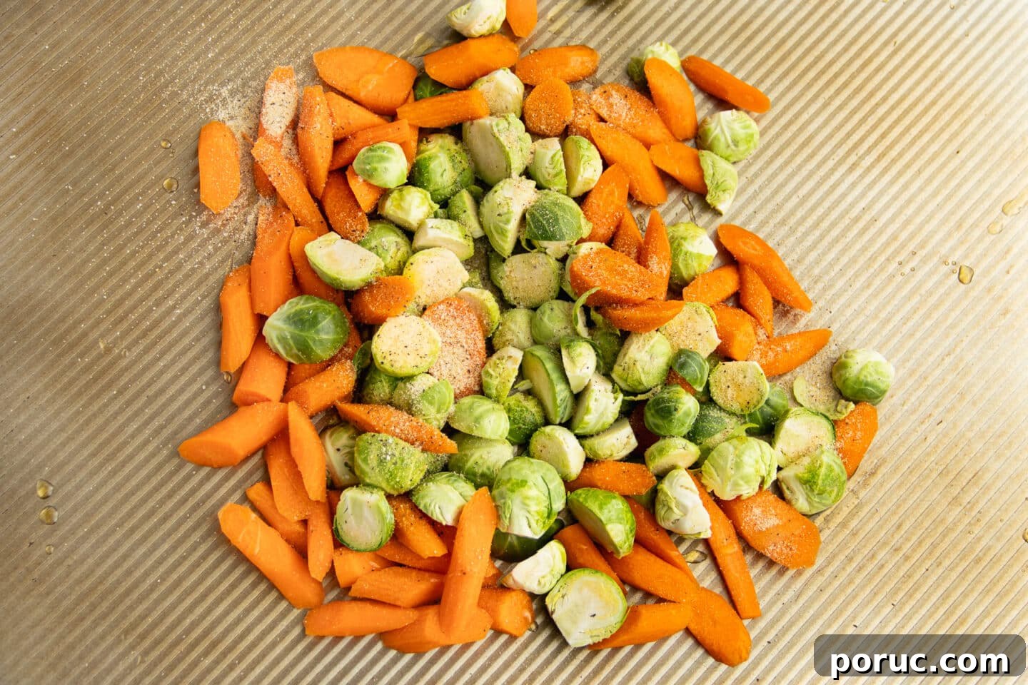 Spicy Honey-Roasted Brussels Sprouts and Carrots 7 This is a picture of the veggies on a baking tray being seasoned.