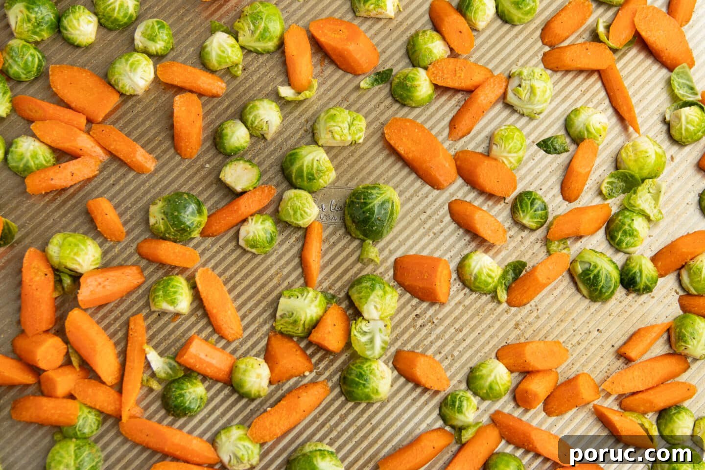 Spicy Honey-Roasted Brussels Sprouts and Carrots 8 This is a picture of the veggies on a baking tray placed on a single layer.