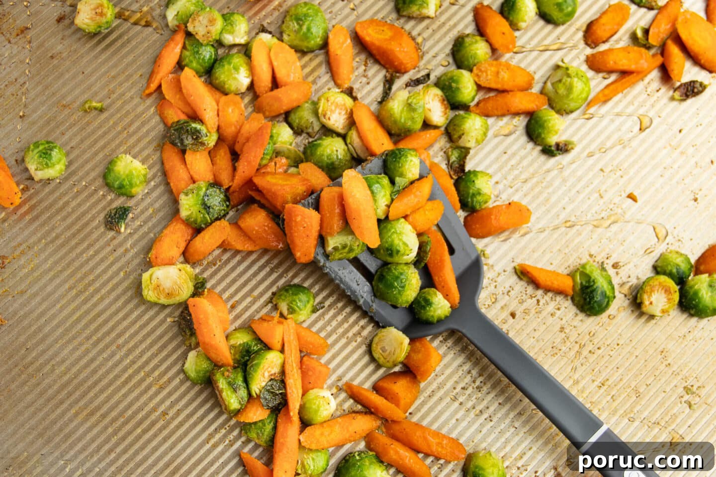 Spicy Honey-Roasted Brussels Sprouts and Carrots 9 This is a picture of the veggies on a baking tray tossed in hot honey.