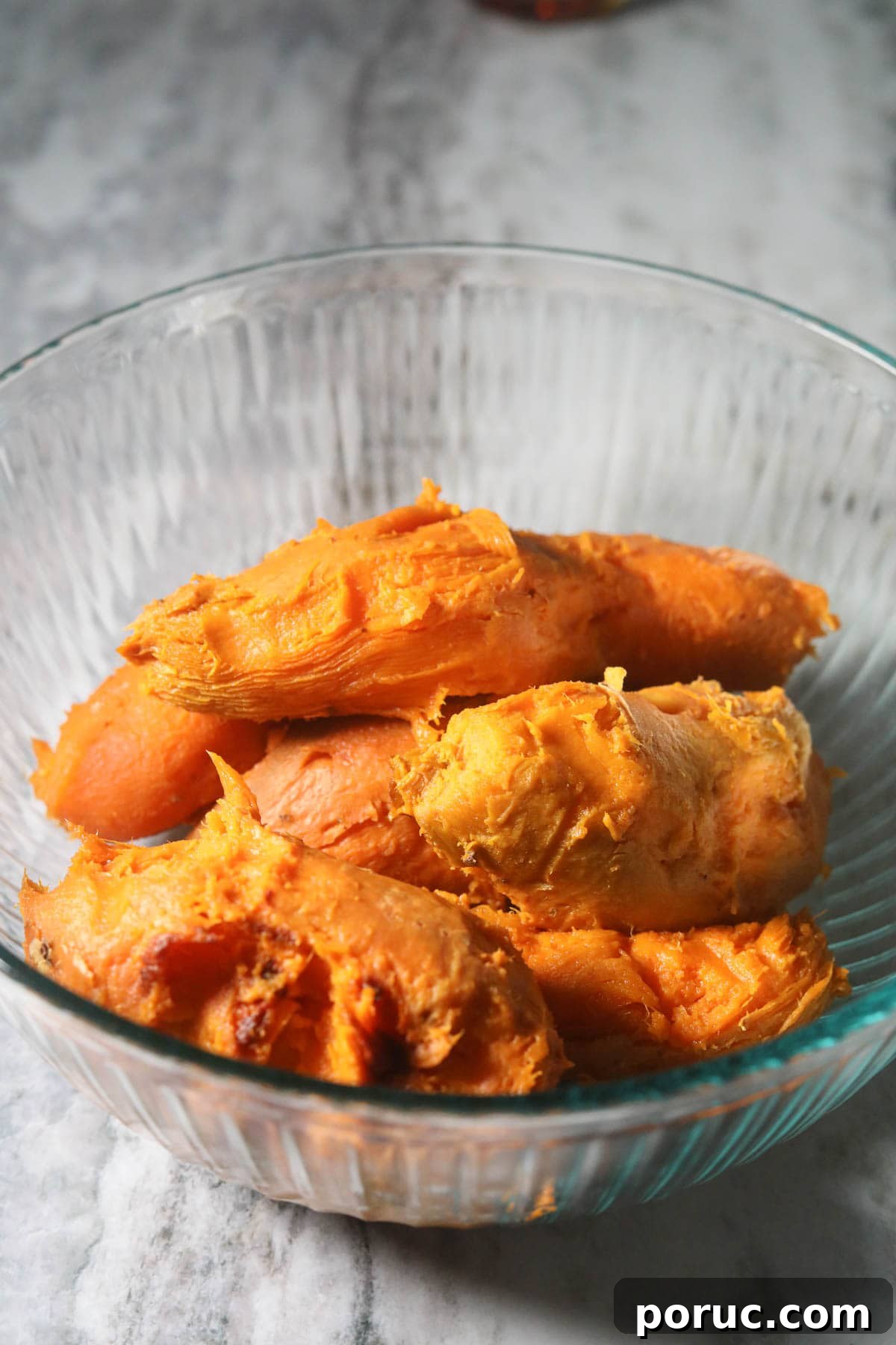 Southern Sweet Potato Casserole with Pecan Crumble Recipe 4 Roasted and peeled sweet potatoes in a mixing bowl.