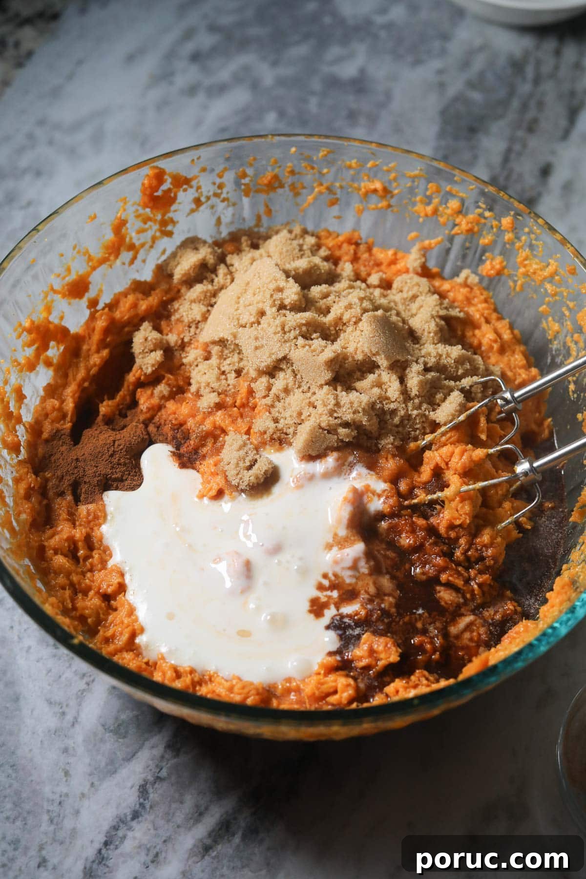 Southern Sweet Potato Casserole with Pecan Crumble Recipe 5 They're sweet potatoes and other ingredients in a large mixing bowl for sweet potato casserole.