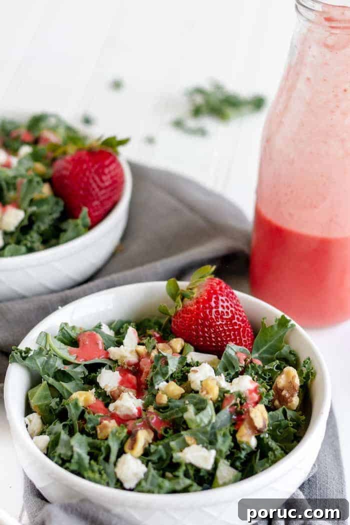 Strawberry Vinaigrette Recipe for Paleo Salads 4 Photo shows two kale salads with strawberries and walnuts, and a bottle of homemade strawberry dressing
