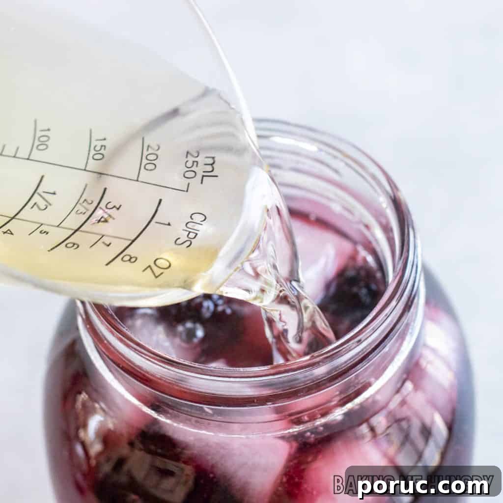 Starbucks-Style Hibiscus Refresher Recipe — How to Make It at Home 8 juice being added to jar