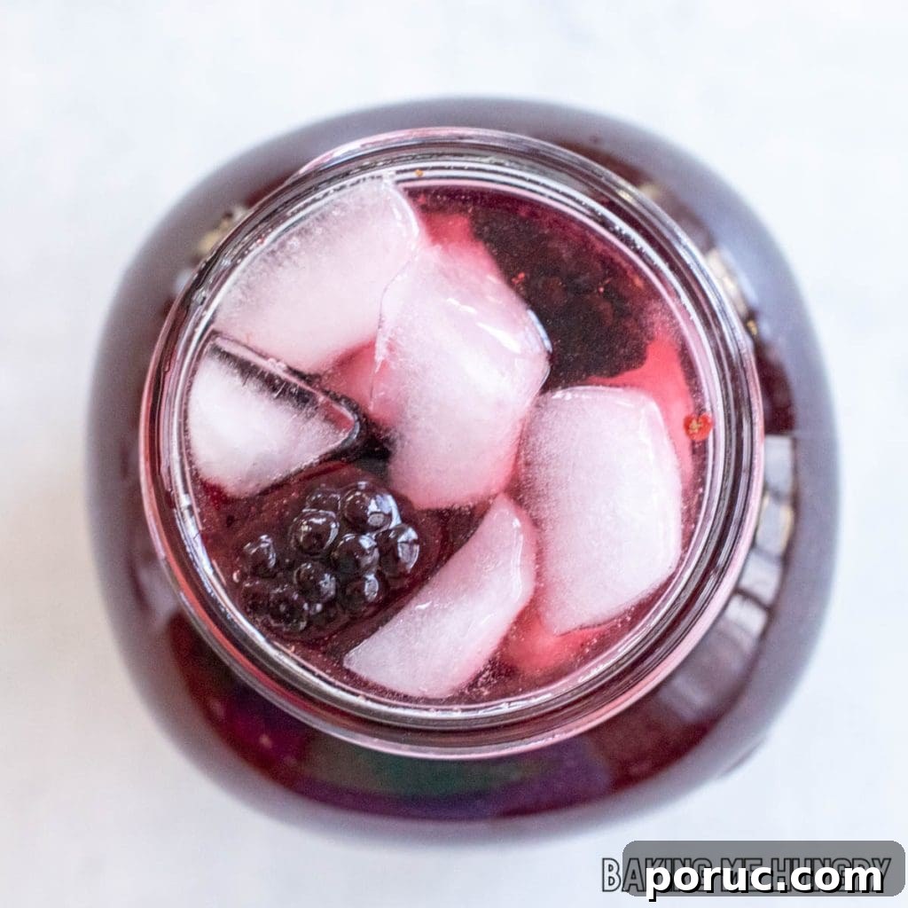 Starbucks-Style Hibiscus Refresher Recipe — How to Make It at Home 10 starbucks hibiscus tea recipe with blackberries in a jar seen from overhead