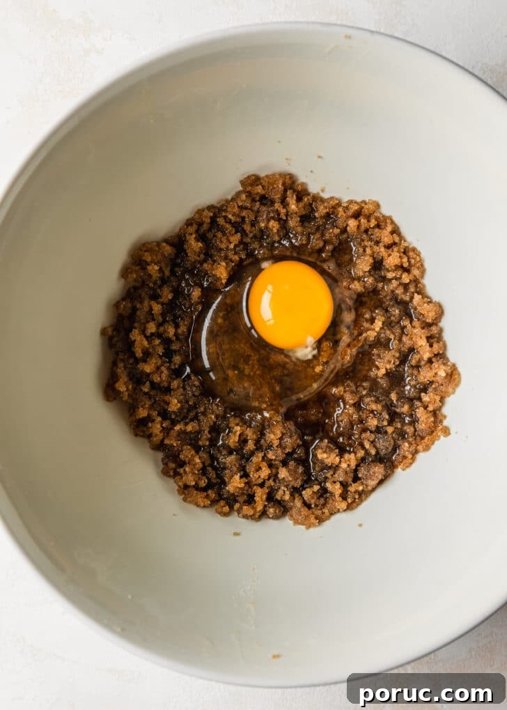 Chewy Mini Chocolate Chip Cookie Recipe for Perfect Bites 10 A white bowl with butter, sugar, and an egg.