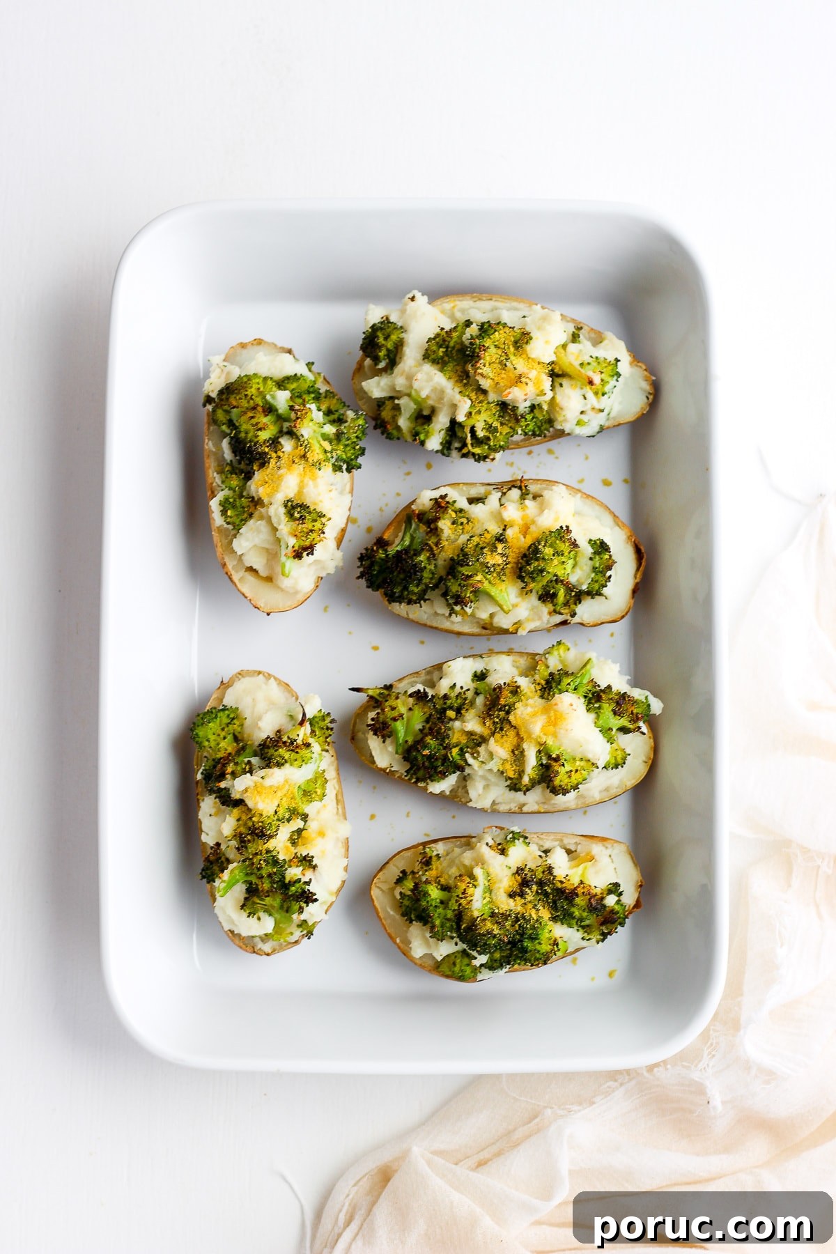 Twice baked potatoes in a white baking dish.