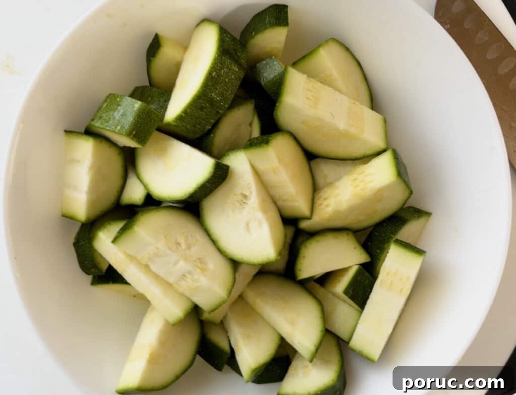 Crispy Air Fryer Zucchini Recipe: Simple Flavorful Side Dish 6 zucchini cut up in a bowl step 3