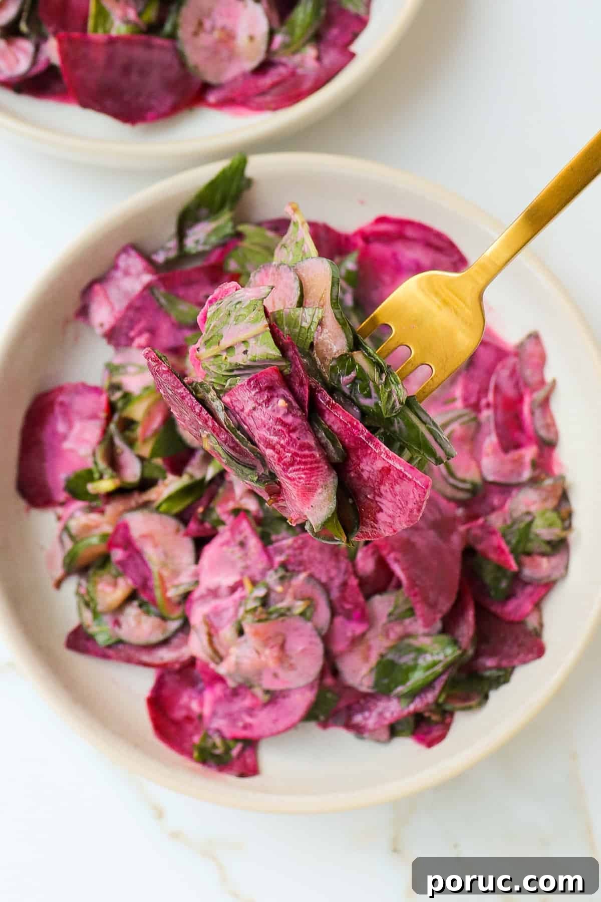 Close up shot of salad on a fork.