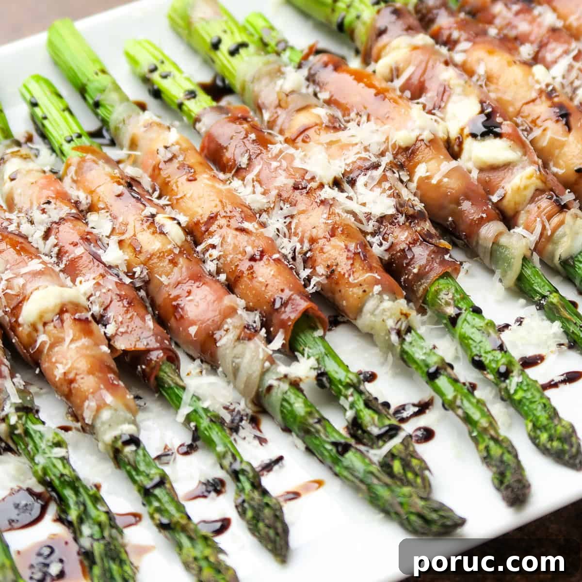 Prosciutto Wrapped Asparagus with Cream Cheese topped with Parmesan cheese and balsamic glaze