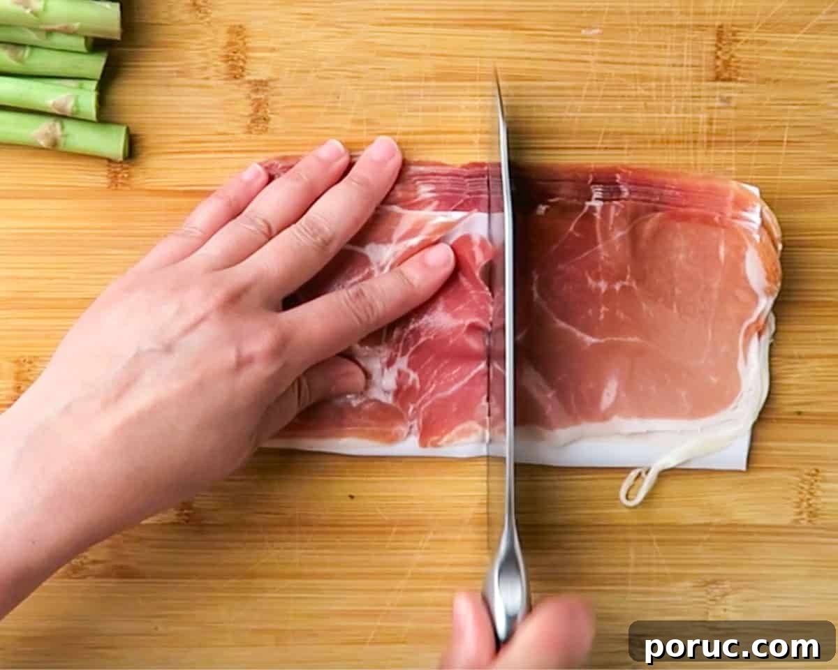 cutting the prosciutto in half 