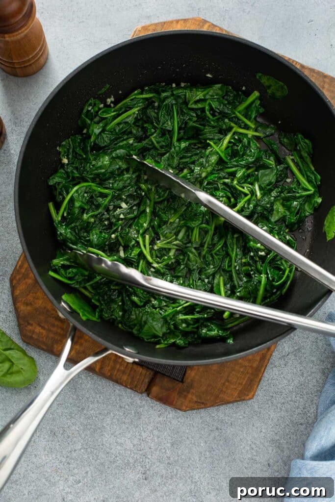 Wilted baby spinach in a skillet