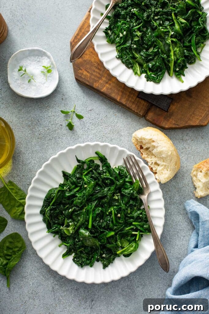 Plates with wilted bay spinach and garlic 