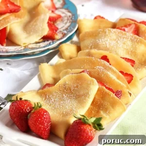 Homemade Crepes: Sweet and Savory Recipes for Any Meal 6 French Crepes stuffed with strawberries on a white platter with fresh berries