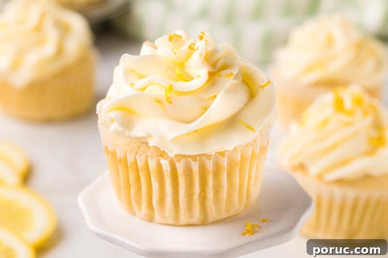 Zesty Lemon Cupcakes Recipe with Simple Glaze 4 Lemon Cupcake on white serving platter.