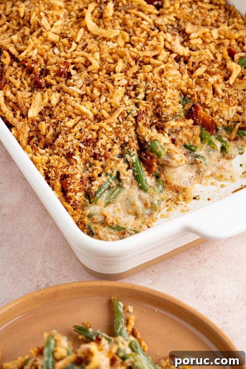Classic Fresh Green Bean Casserole with Crispy Onion Topping 5 Green bean casserole in a white dish on a countertop ready for serving.
