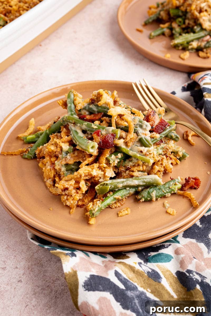 Classic Fresh Green Bean Casserole with Crispy Onion Topping 6 A scoop of green bean casserole on a plate for serving.