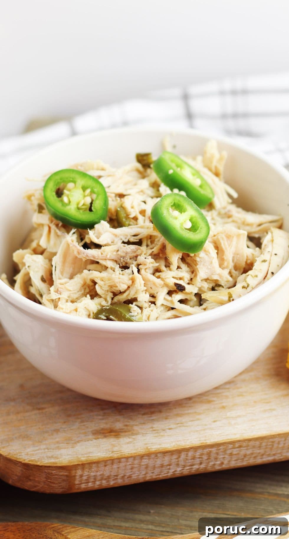 Keto Coconut Lime Shredded Chicken — Instant Pot or Slow Cooker 2 bowl of keto coconut curry chicken on a cutting platter in front of a towel