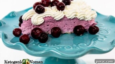 Cranberry mousse with whip cream on blue plate