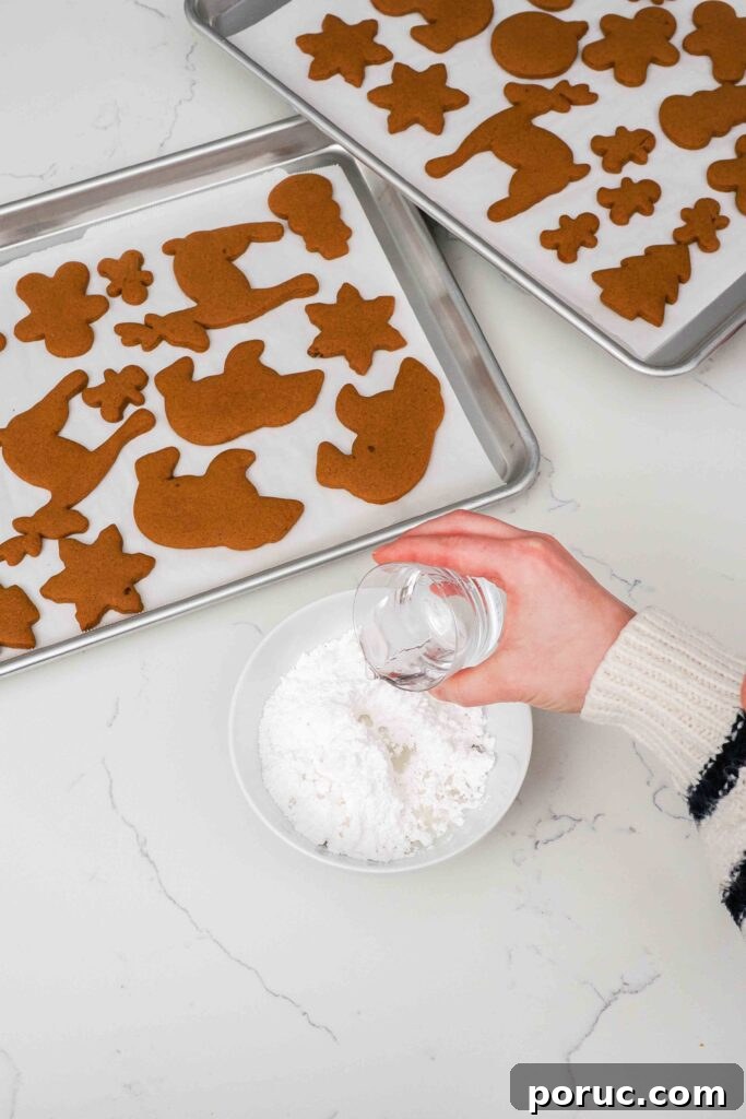 Classic Gingerbread Cookies Recipe for Crisp, Spiced Treats 12 Water is added to a bowl of powdered sugar.