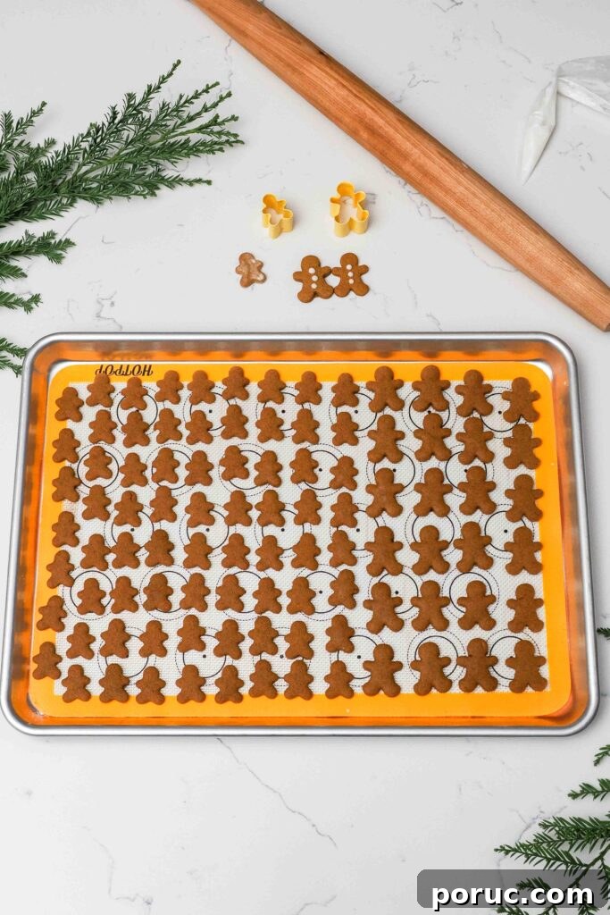 Classic Gingerbread Cookies Recipe for Crisp, Spiced Treats 15 A baking sheet with mini gingerbread cookies.