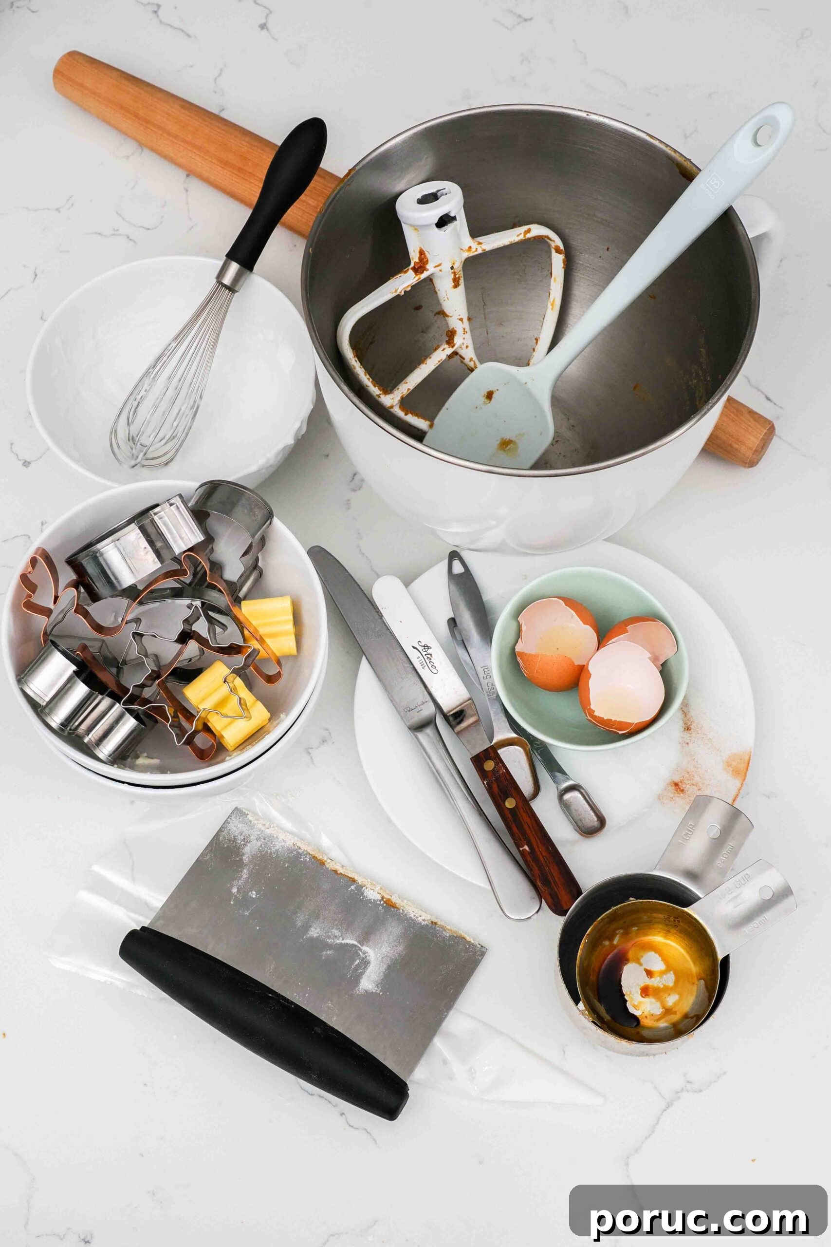Classic Gingerbread Cookies Recipe for Crisp, Spiced Treats 18 Dishes used to make gingerbread cookies on a counter.