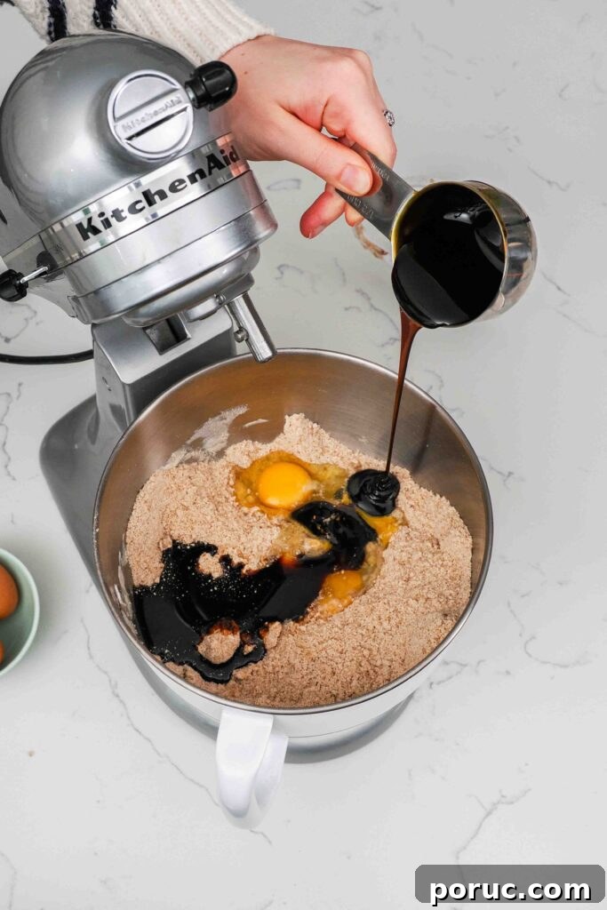 Classic Gingerbread Cookies Recipe for Crisp, Spiced Treats 6 Eggs and molasses are added to a mixer bowl with dry ingredients for gingerbread cookies.