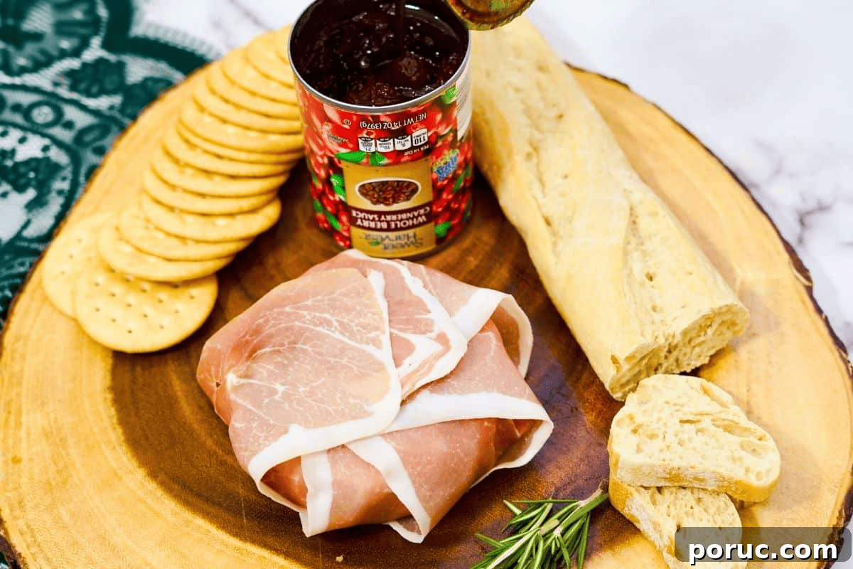 Prosciutto-Wrapped Brie: Baked Appetizer with Honey & Herbs 6 prosciutto wrapped brie with cranberry sauce.