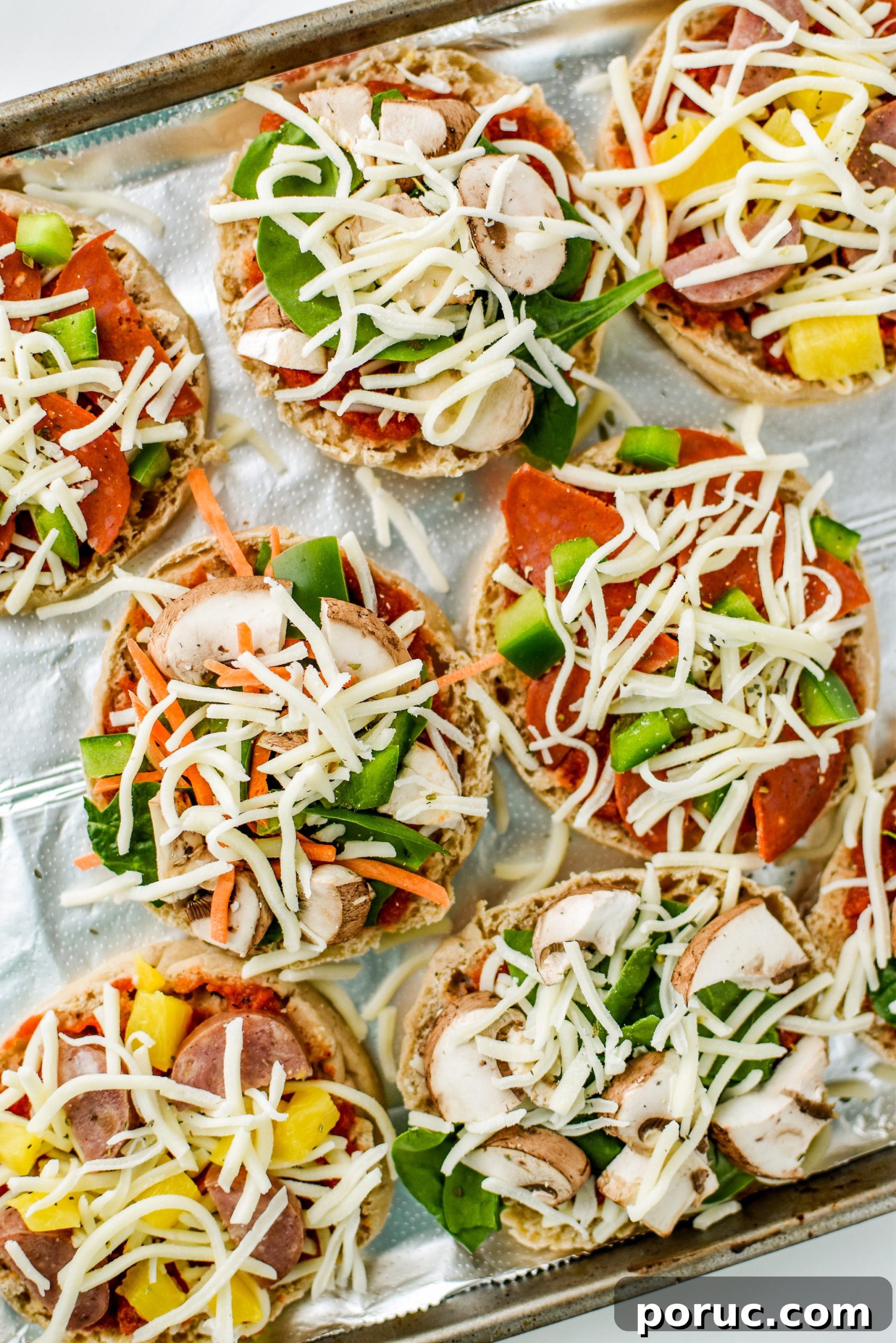 Mini English Muffin Pizzas for Weekly Meal Prep 5 English muffin mini pizzas on a tray before baking!