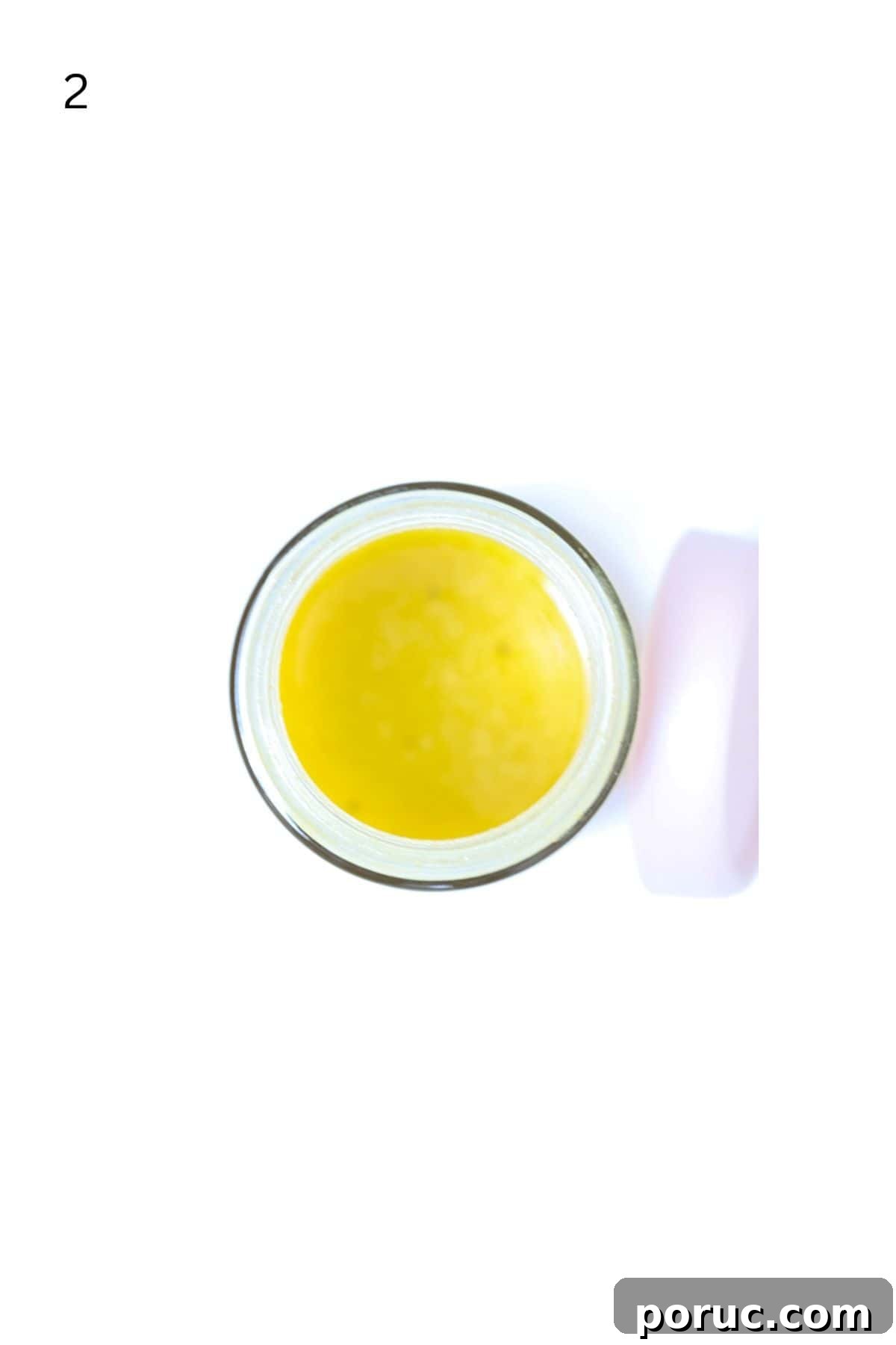 Tangy Apple Cider Vinaigrette Recipe for Salads and Marinades 5 Top view of apple cider vinaigrette salad dressing in a jar with the lid to the side.