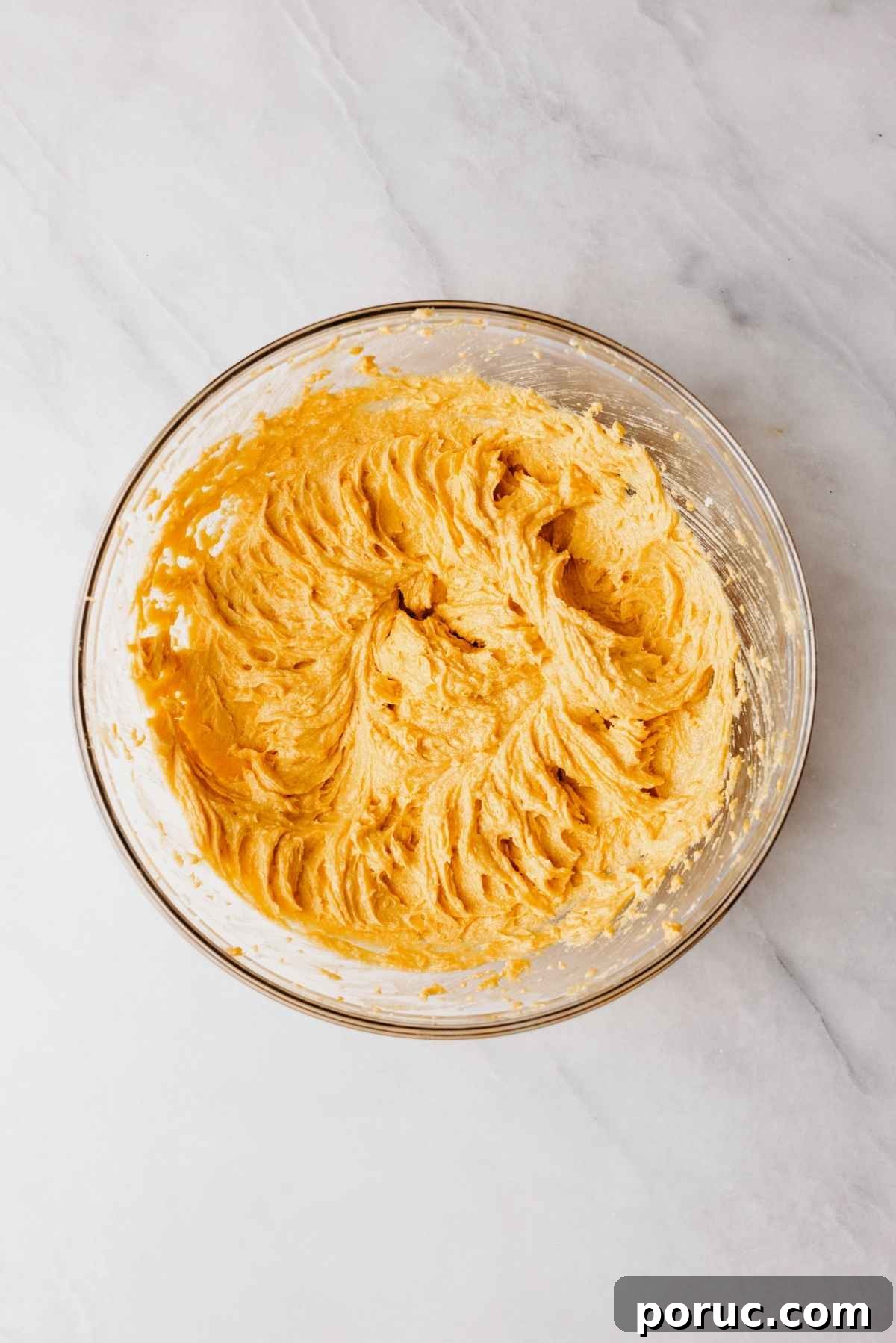 Egg, pumpkin puree, and vanilla extract blended into the shortening and sugar in large glass mixing bowl.