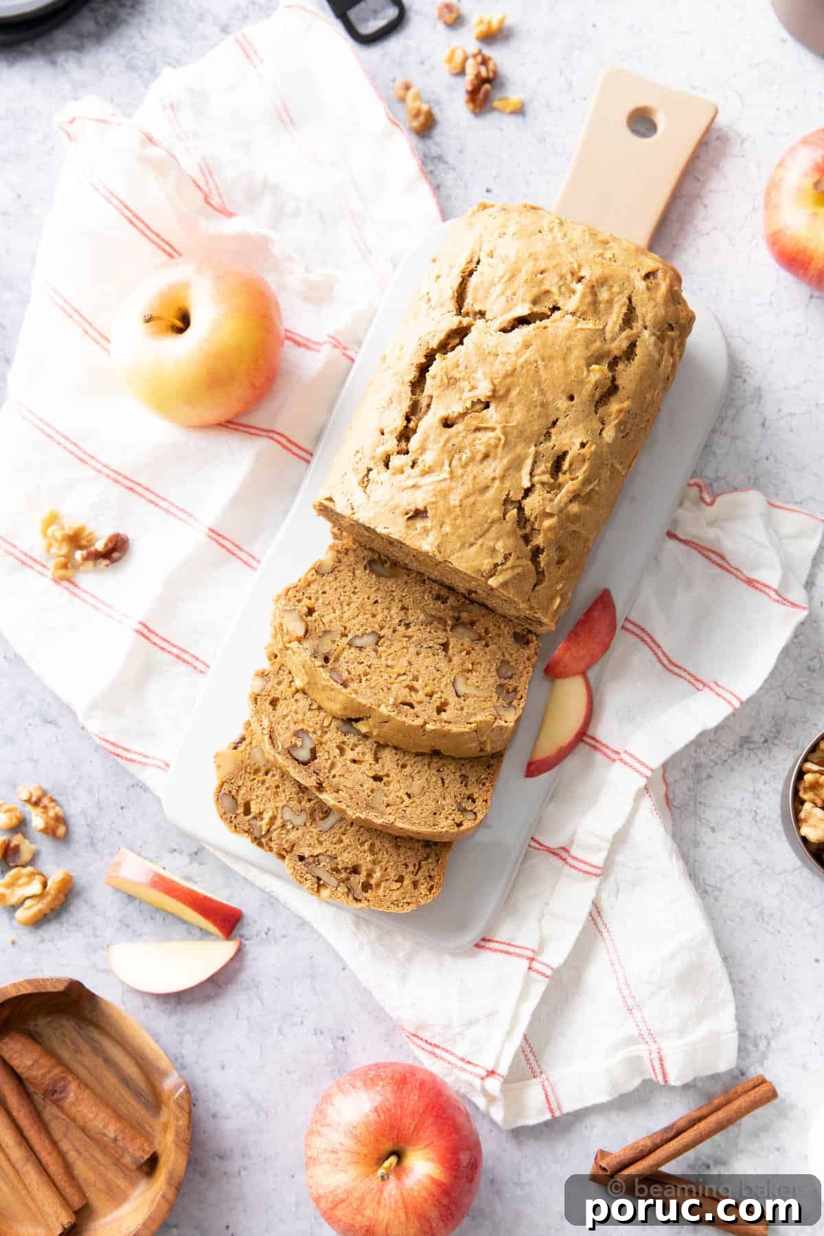Moist Homemade Apple Bread Recipe for Fall Baking 6 Fresh-baked loaf on a kitchen table with ingredients and baking tools
