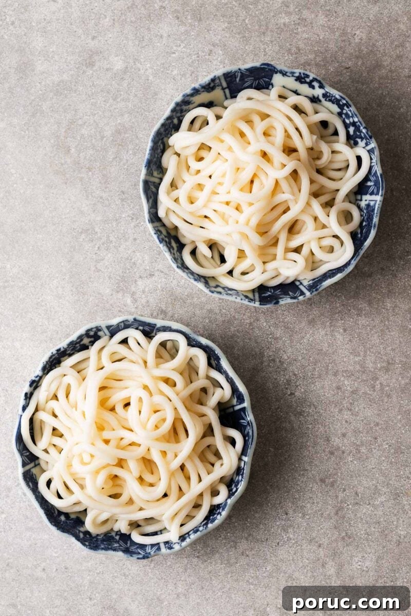 Kake Udon: Classic Japanese Broth Noodle Soup Recipe 9 Two bowls with cooked udon noodles.