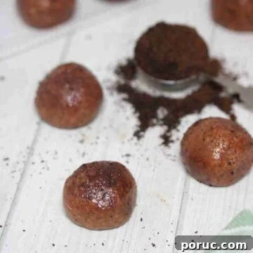 Gluten-Free Coffee Protein Bites: Energy Snacks for Busy Mornings 13 Coffee protein balls covered in cocoa powder with a spoon of coffee grinds beside them.