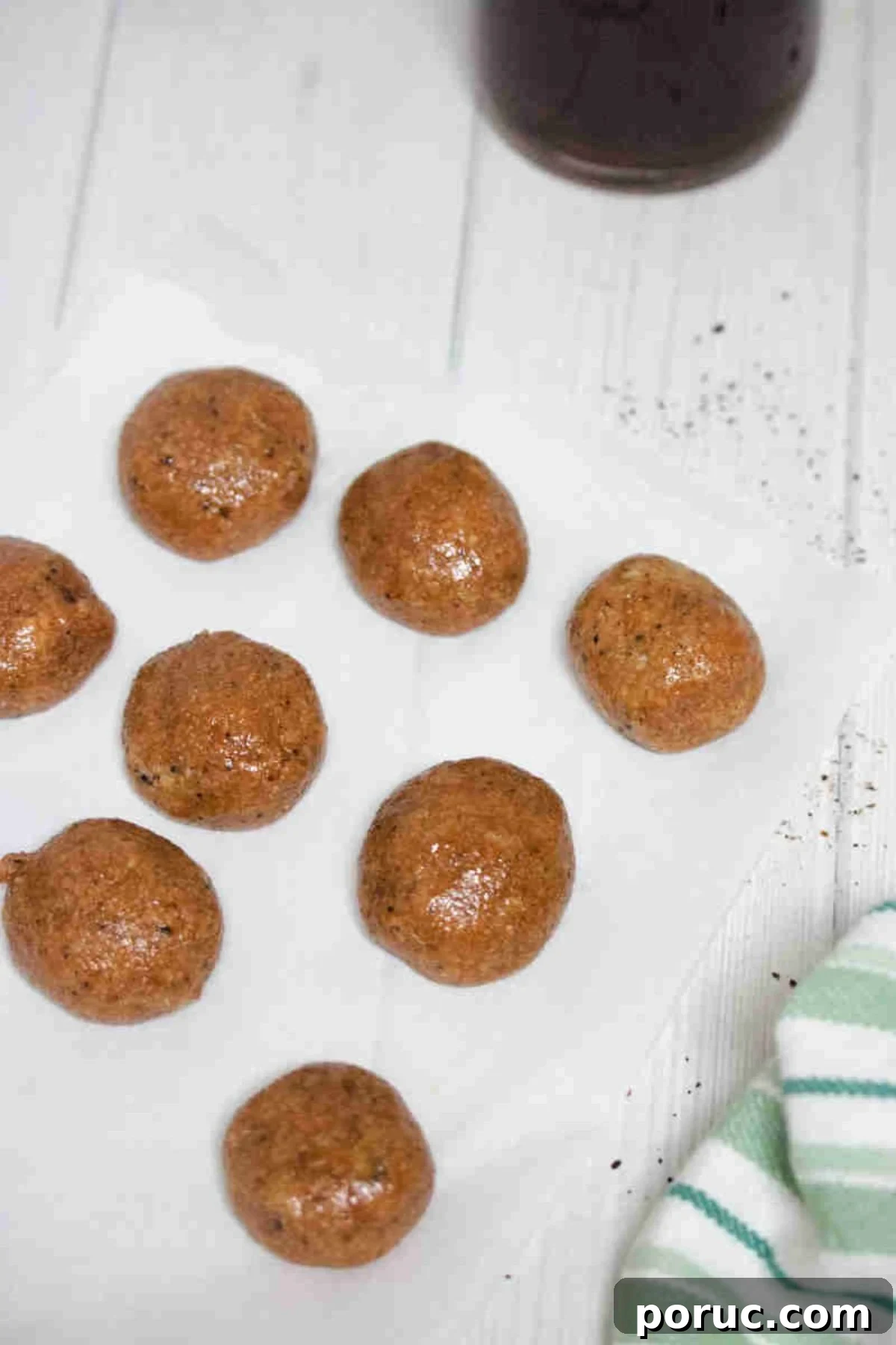 Gluten-Free Coffee Protein Bites: Energy Snacks for Busy Mornings 6 No bake coffee protein balls on parchment paper.