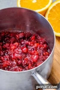 Tangy Cranberry Orange Sauce Recipe for Holidays and Leftovers 14 cooked cranberry sauce in pot.