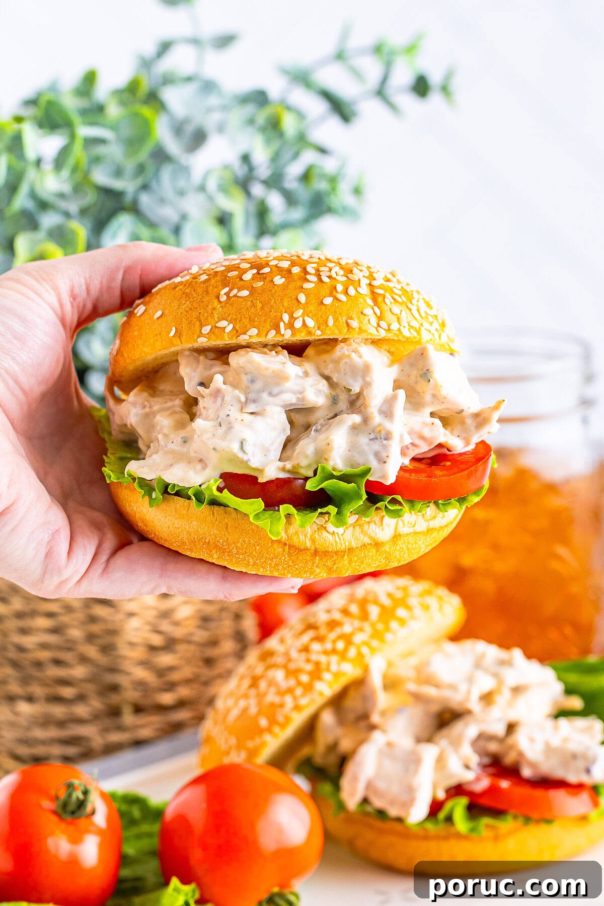 Quick Rotisserie Chicken Salad with Creamy Lemon Dijon Dressing 7 a hand holding up Rotisserie Chicken Salad in a sandwich in air