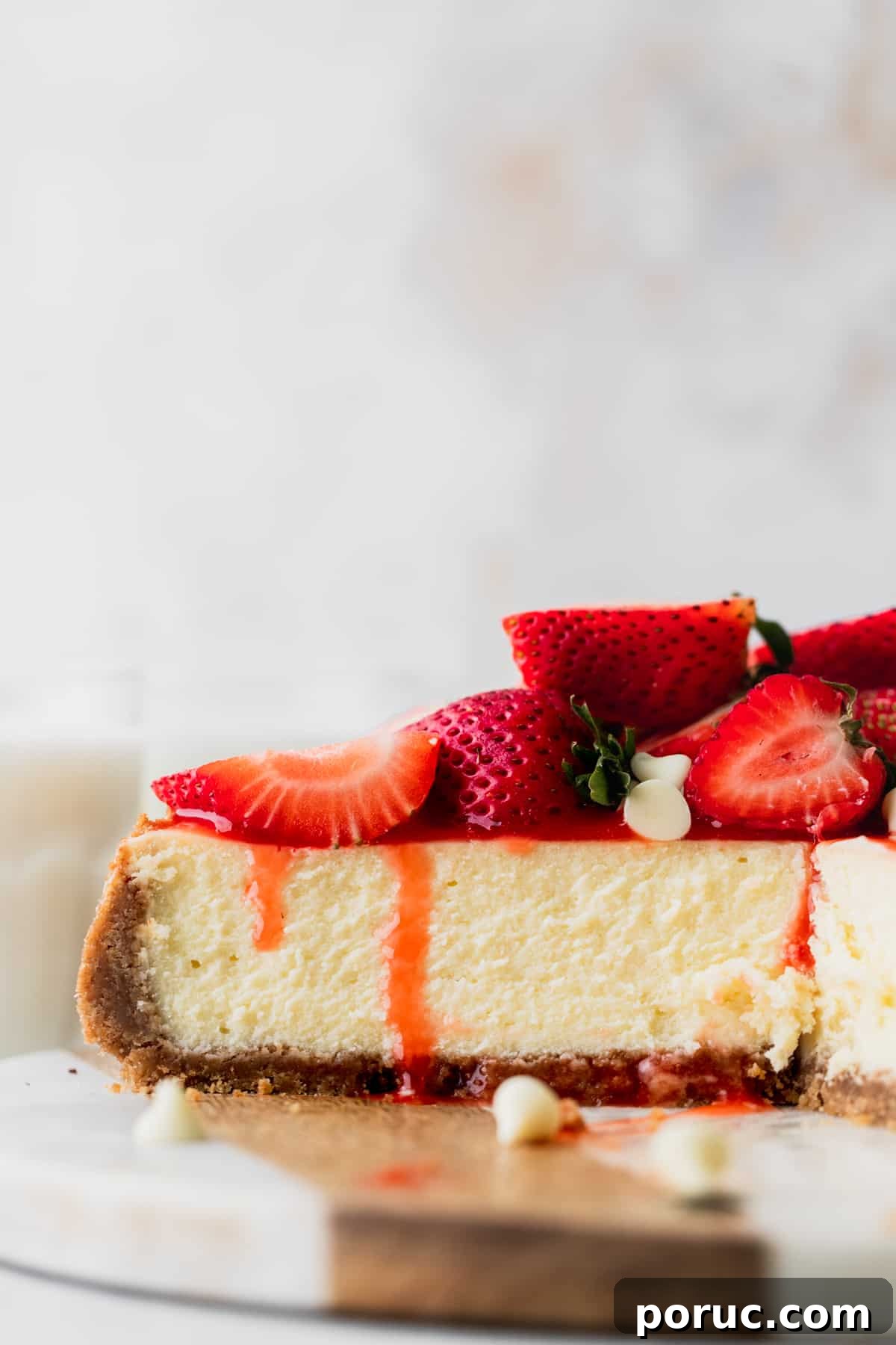 Side view of strawberry white chocolate cheesecake.