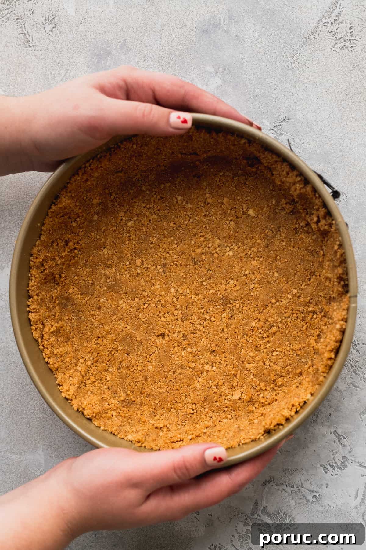 Graham cracker crust in a springform pan.