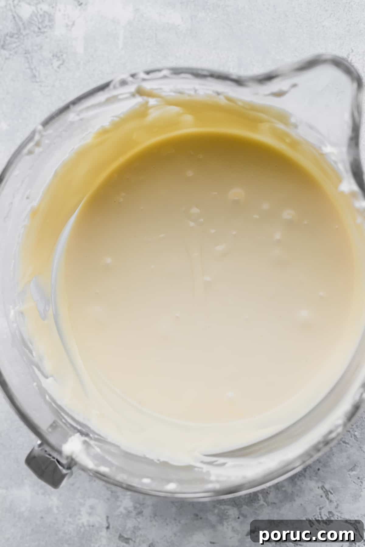 Cheesecake batter in a glass bowl.