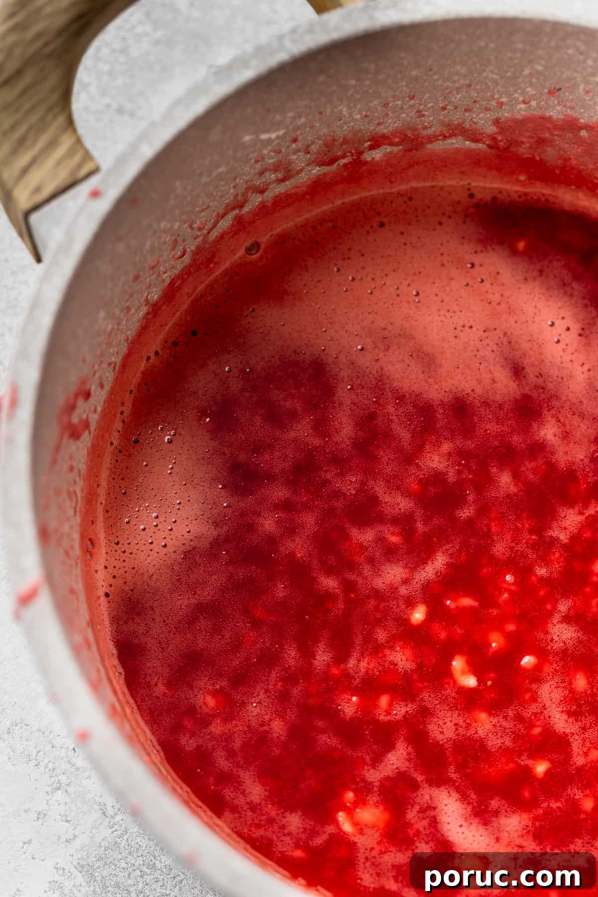 Strawberry glaze in a pot.
