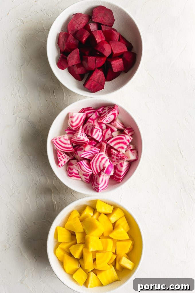 Crispy Air Fryer Roasted Beets: Quick Oven-Free Recipe 4 Red beets, golden beets and Chioggia beets cut into pieces and arranged in individuals white bowls.